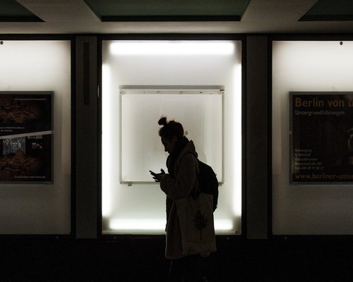 A person comfortably walking down city stairs carrying light bags